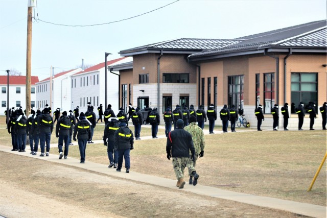 U.S. Navy recruits walk on the cantonment area Dec. 15, 2020, at Fort McCoy, Wis. The Navy’s Recruit Training Command (RTC) of Great Lakes, Ill., worked with the Army at Fort McCoy so the post could serve as a restriction-of-movement (ROM) site...