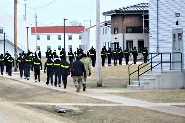 U.S. Navy recruits walk on the cantonment area Dec. 15, 2020, at Fort McCoy, Wis. The Navy’s Recruit Training Command (RTC) of Great Lakes, Ill., worked with the Army at Fort McCoy so the post could serve as a restriction-of-movement (ROM) site...