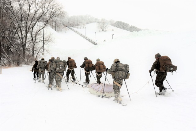 Students in Cold-Weather Operations Course Class 21-02 practice snowshoeing and pulling ahkio sleds with gear as teams Jan. 7, 2021, near Whitetail Ridge Ski Area in Pine View Recreation Area at Fort McCoy, Wis. The course covers a variety of...