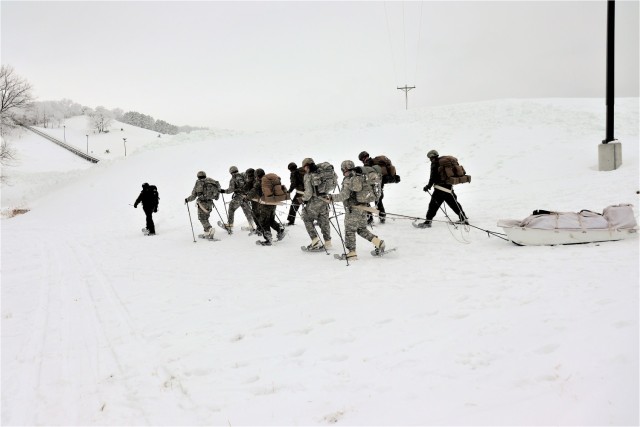 Students in Cold-Weather Operations Course Class 21-01 practice snowshoeing and pulling ahkio sleds with gear as teams Jan. 7, 2021, near Whitetail Ridge Ski Area in Pine View Recreation Area at Fort McCoy, Wis. The course covers a variety of...