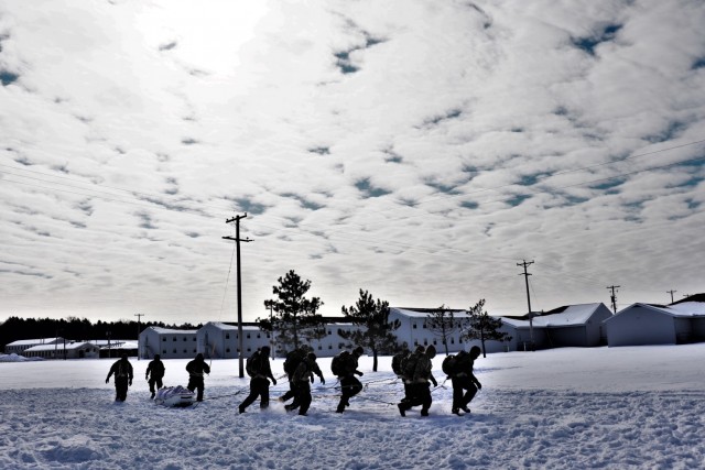 Fort McCoy Cold-Weather Operations Course (CWOC) Class 20-04 students practice pulling an ahkio sled as a squad Feb. 19, 2020, at a training area at Fort McCoy, Wis. CWOC students are trained on a variety of cold-weather subjects, including snowshoe training and skiing as well as how to use ahkio sleds and other gear. Training also focuses on terrain and weather analysis, risk management, cold-weather clothing, developing winter fighting positions in the field, camouflage and concealment, and numerous other areas that are important to know in order to survive and operate in a cold-weather environment. The training is coordinated through the Directorate of Plans, Training, Mobilization and Security at Fort McCoy. (U.S. Army Photo by Scott T. Sturkol, Public Affairs Office, Fort McCoy, Wis.)
