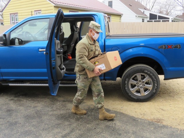 Fort McCoy, Wis., personnel and Soldiers with Headquarters and Headquarters Company (HHC), Fort McCoy Garrison, are shown after they traveled to Couleecap Monroe County Food Pantry in Sparta, Wis., on Dec. 21, 2020, for the third and final...