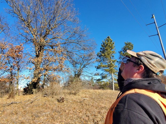 Forestry Technician Nick Randall uses a clinometer to measure the height of a tree while working on a forestry survey on the cantonment area Dec. 4, 2020, at Fort McCoy, Wis. Parry works with the Forestry Office of the Directorate of Public Works...