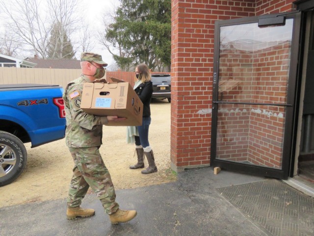 Fort McCoy, Wis., personnel and Soldiers with Headquarters and Headquarters Company (HHC), Fort McCoy Garrison, are shown after they traveled to Couleecap Monroe County Food Pantry in Sparta, Wis., on Dec. 21, 2020, for the third and final...