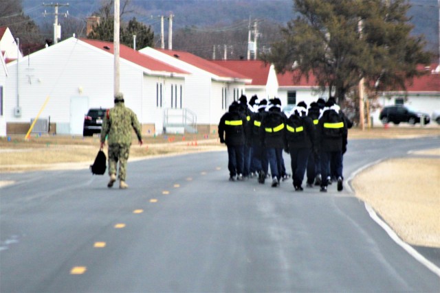 U.S. Navy recruits walk on the cantonment area Dec. 15, 2020, at Fort McCoy, Wis. The Navy’s Recruit Training Command (RTC) of Great Lakes, Ill., worked with the Army at Fort McCoy so the post could serve as a restriction-of-movement (ROM) site...