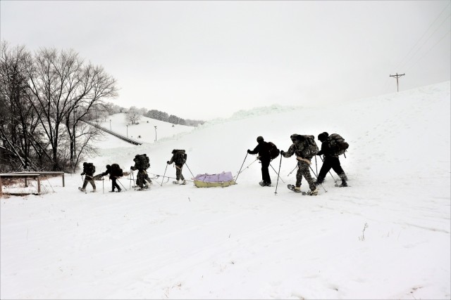 Students in Cold-Weather Operations Course Class 21-02 practice snowshoeing and pulling ahkio sleds with gear as teams Jan. 7, 2021, near Whitetail Ridge Ski Area in Pine View Recreation Area at Fort McCoy, Wis. The course covers a variety of...