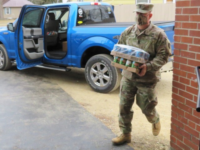 Fort McCoy, Wis., personnel and Soldiers with Headquarters and Headquarters Company (HHC), Fort McCoy Garrison, are shown after they traveled to Couleecap Monroe County Food Pantry in Sparta, Wis., on Dec. 21, 2020, for the third and final...