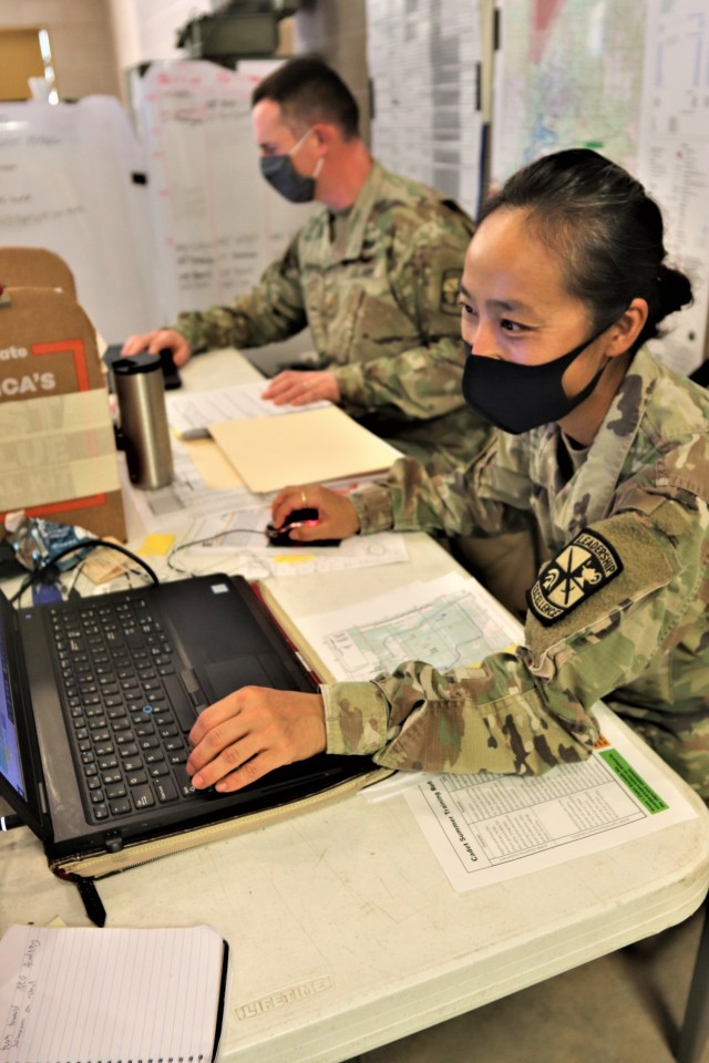 Maj. Dan Bartlett and Capt. Hyeon Kim, both who served as operations officers with ROTC training at Fort McCoy in early August 2020, plan some training Aug. 13, 2020, in a building at the Combined Arms Collective Training Facility on South Post at Fort McCoy, Wis. Dozens of ROTC cadets from seven universities trained at Fort McCoy for 10 days in early August in a special training exercise that was created because of the loss of previous training opportunities for cadets because of the COVID-19 pandemic. (U.S. Army Photo by Scott T. Sturkol, Public Affairs Office, Fort McCoy, Wis.)