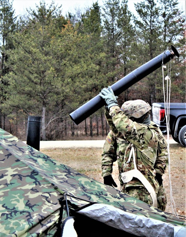 Fort McCoy Cold-Weather Operations Course (CWOC) Class 21-01 students set up an Arctic 10-person tent Dec. 15, 2020, at a South Post training area at Fort McCoy, Wis. CWOC students are trained on a variety of cold-weather subjects, including...