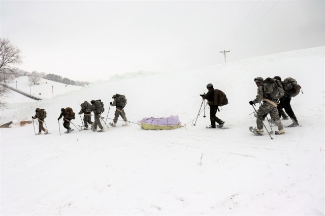 Students in Cold-Weather Operations Course Class 21-02 practice snowshoeing and pulling ahkio sleds with gear as teams Jan. 7, 2021, near Whitetail Ridge Ski Area in Pine View Recreation Area at Fort McCoy, Wis. The course covers a variety of...