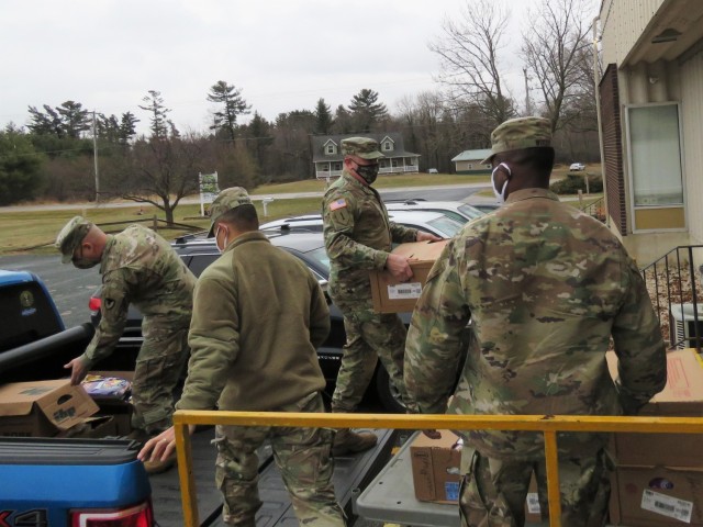Fort McCoy, Wis., personnel and Soldiers with Headquarters and Headquarters Company (HHC), Fort McCoy Garrison, are shown after they traveled to Neighbor-for-Neighbor Inc. in Tomah, Wis., on Dec. 21, 2020, for the third and final drop-off from the...