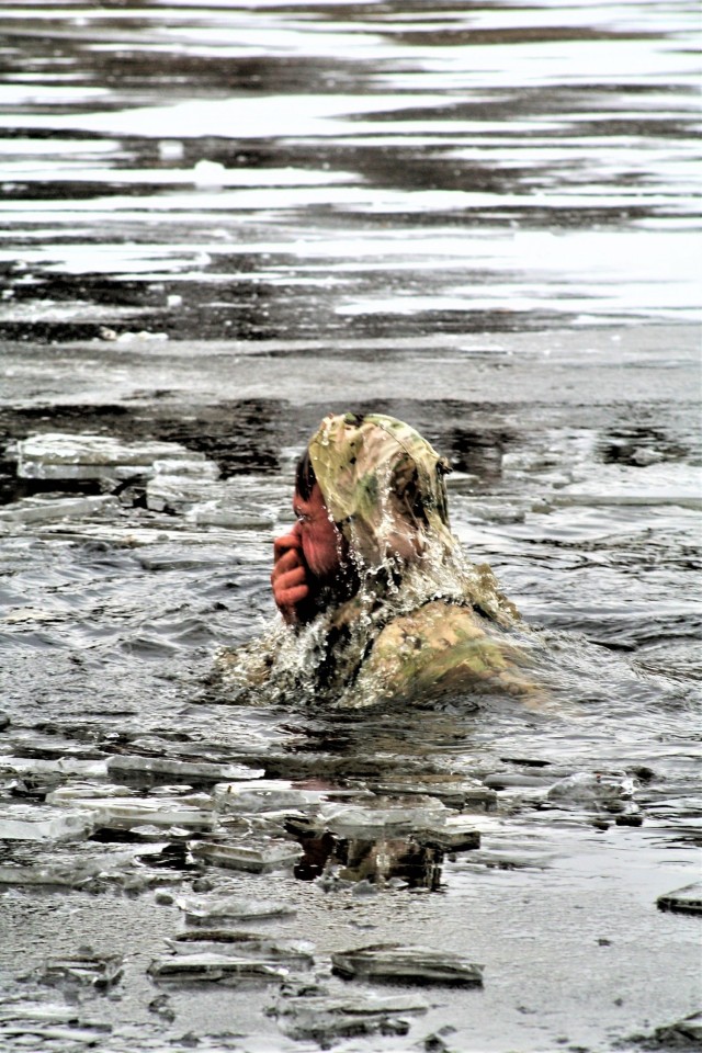 A Fort McCoy Cold-Weather Operations Course (CWOC) Class 21-01 student participates in cold-water immersion training Dec. 15, 2020, at Big Sandy Lake on South Post at Fort McCoy, Wis. CWOC students are trained on a variety of cold-weather subjects, including snowshoe training and skiing as well as how to use ahkio sleds and other gear. Training also focuses on terrain and weather analysis, risk management, cold-weather clothing, developing winter fighting positions in the field, camouflage and concealment, and numerous other areas that are important to know in order to survive and operate in a cold-weather environment. The training is coordinated through the Directorate of Plans, Training, Mobilization and Security at Fort McCoy. (U.S. Army Photo by Scott T. Sturkol, Public Affairs Office, Fort McCoy, Wis.)