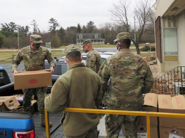 Fort McCoy, Wis., personnel and Soldiers with Headquarters and Headquarters Company (HHC), Fort McCoy Garrison, are shown after they traveled to Neighbor-for-Neighbor Inc. in Tomah, Wis., on Dec. 21, 2020, for the third and final drop-off from the...