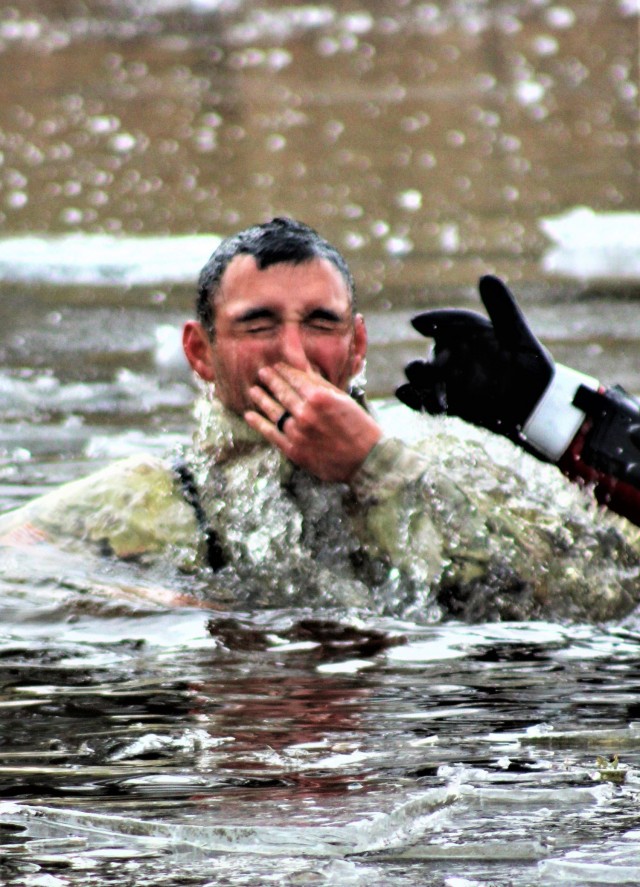 A Fort McCoy Cold-Weather Operations Course (CWOC) Class 21-01 student participates in cold-water immersion training Dec. 15, 2020, at Big Sandy Lake on South Post at Fort McCoy, Wis. CWOC students are trained on a variety of cold-weather subjects, including snowshoe training and skiing as well as how to use ahkio sleds and other gear. Training also focuses on terrain and weather analysis, risk management, cold-weather clothing, developing winter fighting positions in the field, camouflage and concealment, and numerous other areas that are important to know in order to survive and operate in a cold-weather environment. The training is coordinated through the Directorate of Plans, Training, Mobilization and Security at Fort McCoy. (U.S. Army Photo by Scott T. Sturkol, Public Affairs Office, Fort McCoy, Wis.)