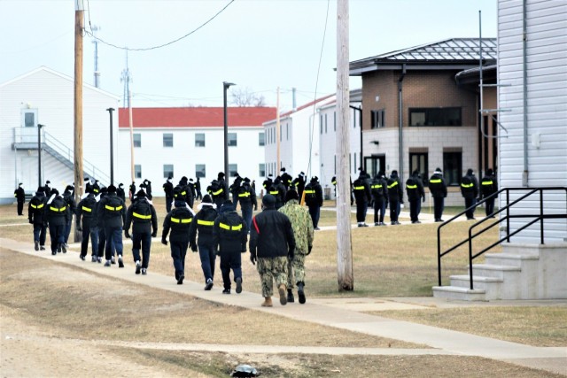 U.S. Navy recruits walk on the cantonment area Dec. 15, 2020, at Fort McCoy, Wis. The Navy’s Recruit Training Command (RTC) of Great Lakes, Ill., worked with the Army at Fort McCoy so the post could serve as a restriction-of-movement (ROM) site...