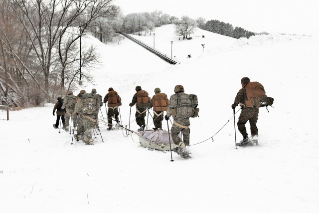 Students in Cold-Weather Operations Course Class 21-02 practice snowshoeing and pulling ahkio sleds with gear as teams Jan. 7, 2021, near Whitetail Ridge Ski Area in Pine View Recreation Area at Fort McCoy, Wis. The course covers a variety of...