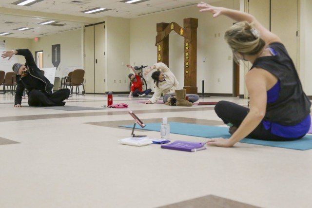 A group of Soldier Family Readiness Group members participate in a ‘Yoga for Spouses’ class hosted by the Headquarters and Headquarters Battalion, 1st Infantry Division, SFRG at the HHBN headquarters building on Fort Riley, Kansas, Jan. 12, 2021. The event was hosted to promote health and wellness within families throughout the battalion. (U.S. Army photo by Spc. Alvin Conley)