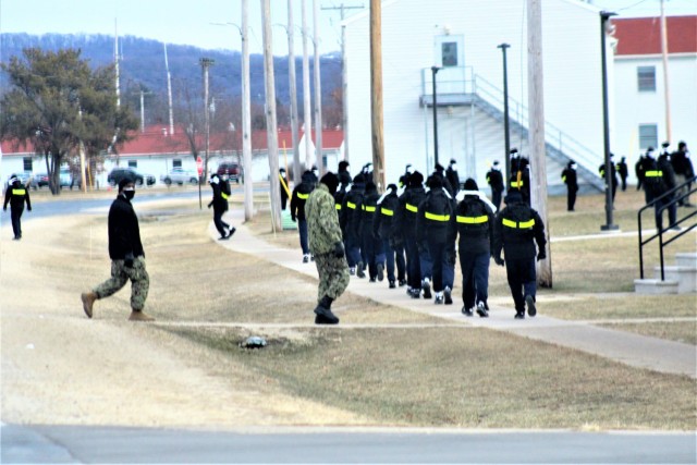 U.S. Navy recruits walk on the cantonment area Dec. 15, 2020, at Fort McCoy, Wis. The Navy’s Recruit Training Command (RTC) of Great Lakes, Ill., worked with the Army at Fort McCoy so the post could serve as a restriction-of-movement (ROM) site...