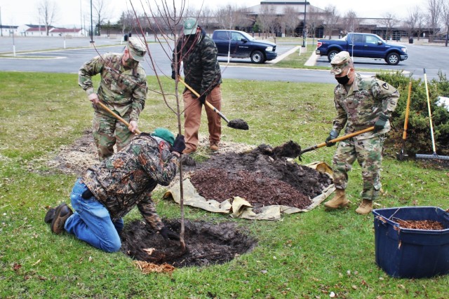 Garrison staff members, all practicing social distancing and other protective measures, plant a tree during the installation’s 2020 Arbor Day observance April 24, 2020, at Fort McCoy, Wis. For the ceremony held in front of McCoy’s Community Center, a single maple tree was planted to represent the importance of the day. Fort McCoy Garrison Commander Col. Hui Chae Kim read the Arbor Day proclamation to recognize Fort McCoy’s commitment to preserving forest lands and to observe the installation as a Tree City USA. (U.S. Army Photo by Scott T. Sturkol, Public Affairs Office, Fort McCoy, Wis.)