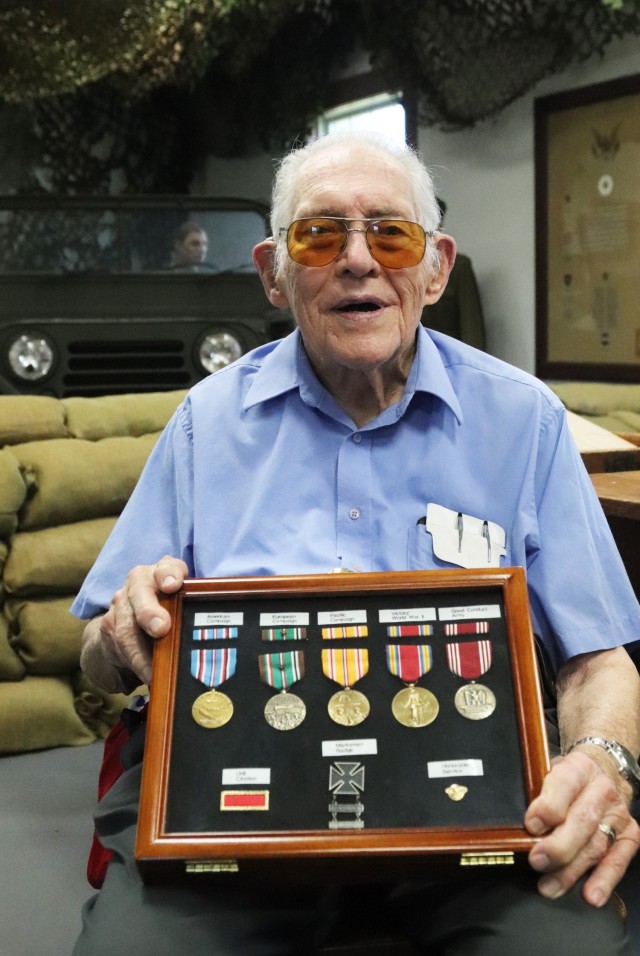 World War II veteran Donald Whitaker of Elk Grove, Wis., and originally from Du-Page County, Ill., is pictured with medals he earned in the war July 16, 2020, while visiting the Fort McCoy, Wis., Commemorative Area.  A special visit was set up for Whitaker, who outprocessed from Fort McCoy in 1946. (Photo by Scott T. Sturkol, Public Affairs Office, Fort McCoy, Wis.)