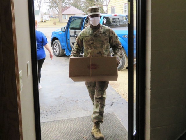 Fort McCoy, Wis., personnel and Soldiers with Headquarters and Headquarters Company (HHC), Fort McCoy Garrison, are shown after they traveled to Couleecap Monroe County Food Pantry in Sparta, Wis., on Dec. 21, 2020, for the third and final...
