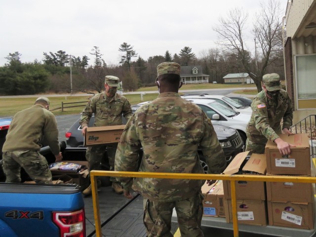 Fort McCoy, Wis., personnel and Soldiers with Headquarters and Headquarters Company (HHC), Fort McCoy Garrison, are shown after they traveled to Neighbor-for-Neighbor Inc. in Tomah, Wis., on Dec. 21, 2020, for the third and final drop-off from the...