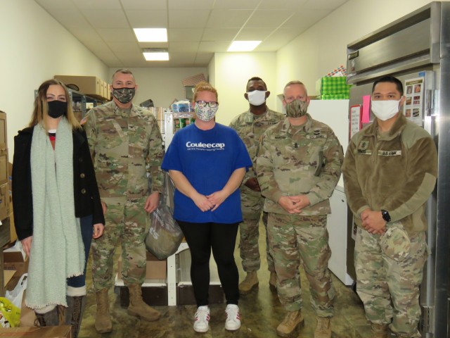 Fort McCoy, Wis., personnel and Soldiers with Headquarters and Headquarters Company (HHC), Fort McCoy Garrison, are shown after they traveled to Couleecap Monroe County Food Pantry in Sparta, Wis., on Dec. 21, 2020, for the third and final...