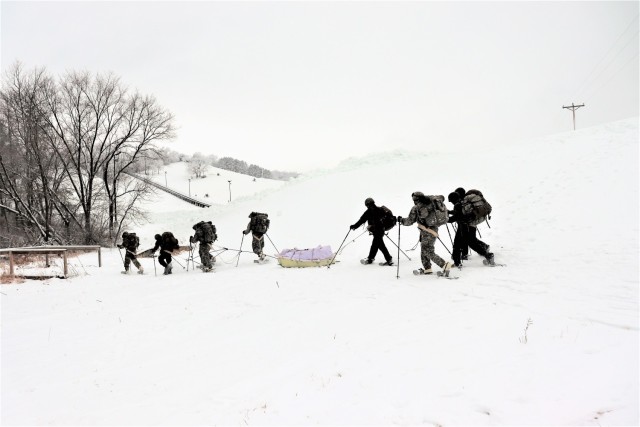 Students in Cold-Weather Operations Course Class 21-02 practice snowshoeing and pulling ahkio sleds with gear as teams Jan. 7, 2021, near Whitetail Ridge Ski Area in Pine View Recreation Area at Fort McCoy, Wis. The course covers a variety of...