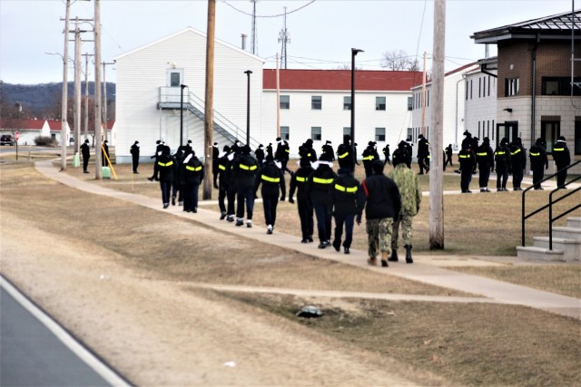 U.S. Navy recruits walk on the cantonment area Dec. 15, 2020, at Fort McCoy, Wis. The Navy’s Recruit Training Command (RTC) of Great Lakes, Ill., worked with the Army at Fort McCoy so the post could serve as a restriction-of-movement (ROM) site...