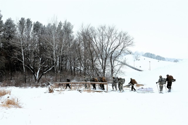 Students in Cold-Weather Operations Course Class 21-02 practice snowshoeing and pulling ahkio sleds with gear as teams Jan. 7, 2021, near Whitetail Ridge Ski Area in Pine View Recreation Area at Fort McCoy, Wis. The course covers a variety of...
