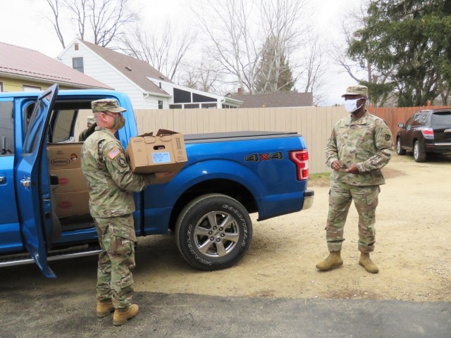 Fort McCoy, Wis., personnel and Soldiers with Headquarters and Headquarters Company (HHC), Fort McCoy Garrison, are shown after they traveled to Couleecap Monroe County Food Pantry in Sparta, Wis., on Dec. 21, 2020, for the third and final...