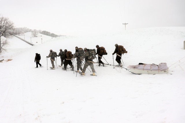 Students in Cold-Weather Operations Course Class 21-01 practice snowshoeing and pulling ahkio sleds with gear as teams Jan. 7, 2021, near Whitetail Ridge Ski Area in Pine View Recreation Area at Fort McCoy, Wis. The course covers a variety of...