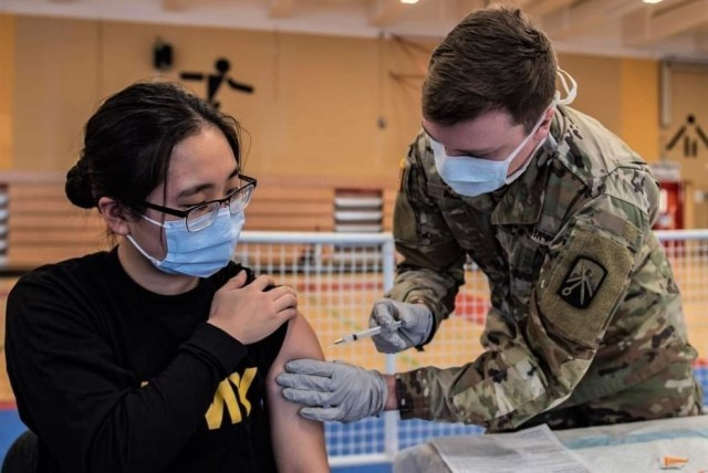 Army Spc. Hana Lee, a dental specialist assigned to the Baumholder Army Dental Clinic, receives her first dose of the COVID vaccine. Dental care providers and staff were included as part of the initial distribution since performing dental...