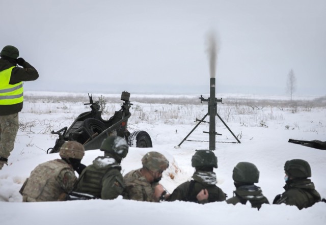 U.S. Capt. Spenser Swafford, 2nd Battalion, 8th Cavalry Regiment fire support officer, fires a Lithuanian 120 mm mortar system during a joint training events Jan. 31, 2021, at Kazlu Ruda, Lithuania. The base is the home of the 22nd Battalion of...