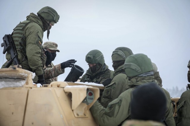 U.S. Staff Sgt. Stephan Hudson, 2nd Battalion, 8th Cavalry Regiment mortar section NCO, demonstrates an optic used on the U.S. M1064, 120mm Mortar Carrier System to members of a Lithuanian mortar team Jan. 13, 2021. The 2-8 Cav. Reg. mortar team...