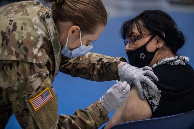 Joanna Baker, a clinical laboratory scientist on Fort Jackson since 1968, receives her COVID vaccination from Capt. Sarah Sauers at the Solomon Center, Jan. 11.