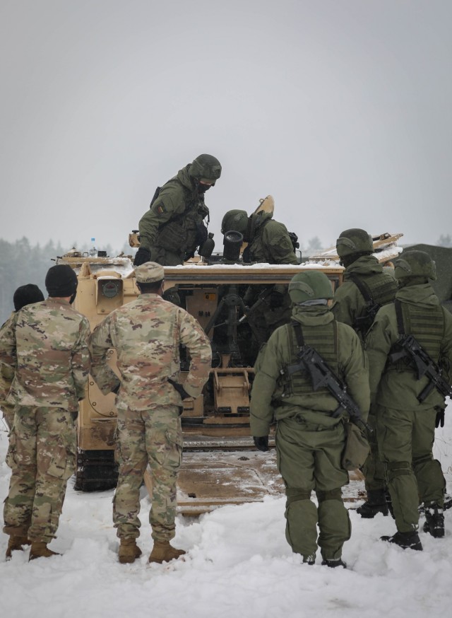 Lithuanian mortar teams explore a U.S. M1064, 120mm Mortar Carrier System Jan. 13, 2021, at Kazlu Ruda, Lithuania. U.S. and Lithuanian forces took advantage of an opportunity to train together on their similar mortar systems and to demonstrate the...