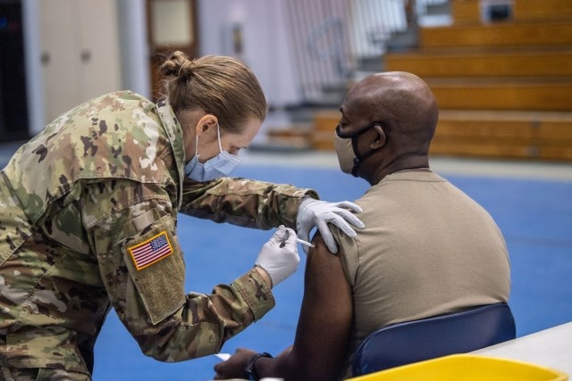Fort Jackson commander Brig. Gen. Milford H. “Beags” Beagle Jr. receives a COVID vaccine shot from Capt. Sarah Sauers Jan. 11 at the Solomon Center. Fort Jackson began vaccinating personnel Jan. 11 based on a phased system.