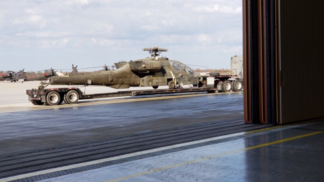 An Apache helicopter is loaded on a truck for relocation from Fort Drum, New York, to the Logistics Services International, Inc. facility in Jacksonville, Florida, October 2020. (Courtesy photo)