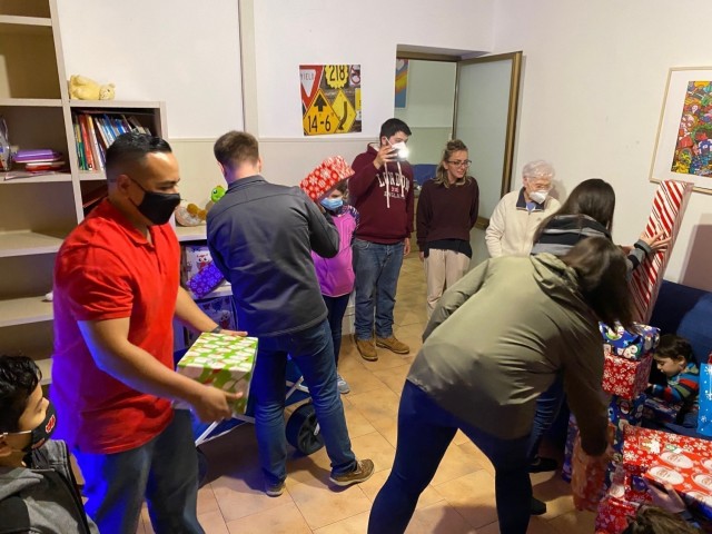 Staff Sgt. Paul Gutierrez, Joint Tactical Ground Station-Italy at Naval Air Station Sigonella, Sicily, delivers gifts to local Italian children at the Alba Chiara Orphanage in Acireale as part of a holiday toy drive, Dec. 21, 2020. The JTAGS unit...