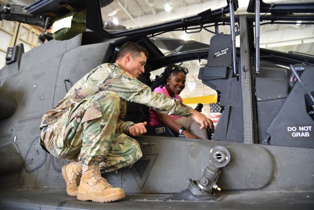 Destinee Croom, an item manager for Black Hawk helicopters, speaks with Maj. Matthew Brown about Apache aircraft components in 2018. (Photo by Preston Benson, RTC)