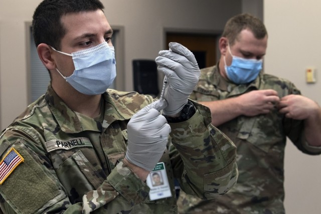 Sgt. Wayne Parnell, a healthcare specialist at Moncrief Army Health Clinic, fills a syringe with COVID-19 vaccine Jan. 8 at the Solomon Center on Fort Jackson.