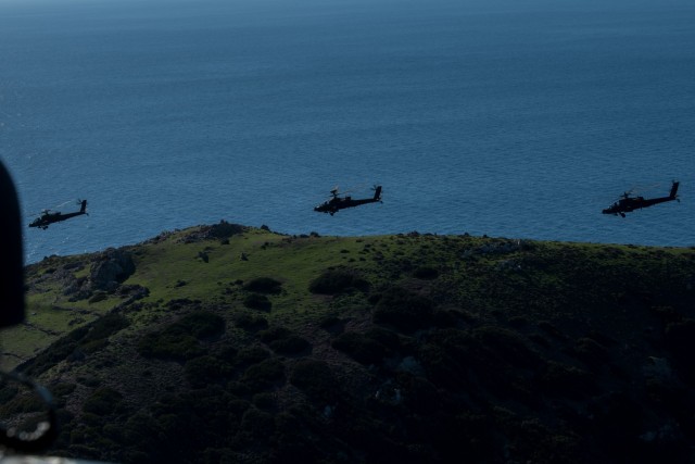 Three U.S. Army AH-64E Apache attack helicopters assigned to 1st, 101st Combat Aviation Brigade, 101st Airborne Division (Air Assault) fly over Velopoula Island in the Aegean Sea in Greece, Jan. 14, 2021. The helicopters took part in Eddie’s...
