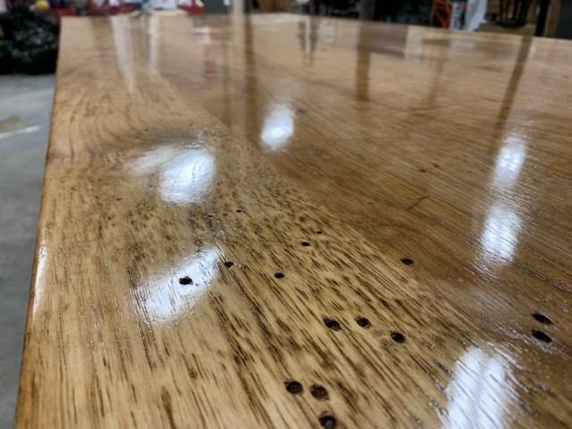 Quartermaster Museum volunteer Lee Holland spent 100 hours refinishing the M-1903 mess hall table found in a World War II-era building on Fort Lee in 1998. In this photo, the chestnut wood is marked with wormholes.