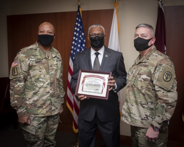 Brig. Gen. Shan Bagby, commander, Brooke Army Medical Center, left, and Command Sgt. Maj. Thurman Reynolds, far right, present a certificate of appreciation to retired Army Col. (Dr.) Kenneth Kemp, BAMC pulmonary and critical care medicine physician, and ordained Baptist minister, Jan. 14, 2021. Kemp was the keynote speaker for BAMC’s virtual observance of Dr. Martin Luther King Jr. Day. (U.S. Army photo by Jason W. Edwards)