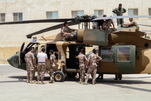 Soldiers of Bravo Company, 449th Aviation Support Battalion, Texas Army National Guard, and members of the Royal Jordanian air force inspect components of a UH-60M Black Hawk helicopter during joint training at a base outside of Amman, Jordan in...