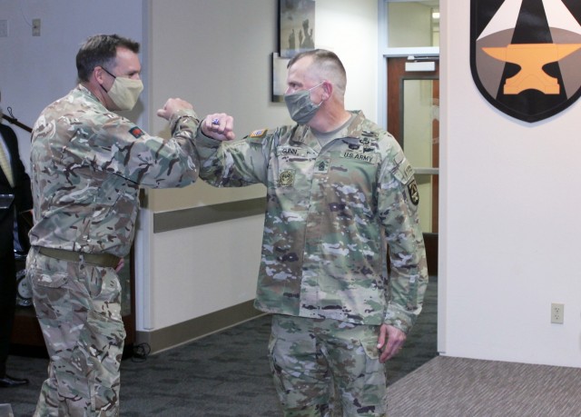 Command Sgt. Maj. Christopher Gunn (right) is greeted by Lt. Col. Kevin Taaffe of the British Army following Gunn’s Relinquishment of Responsibility Ceremony on Jan. 19 at Fort Bliss, Texas. (Photo by Maj. Mike Van Kleeck / U.S. Army Joint...