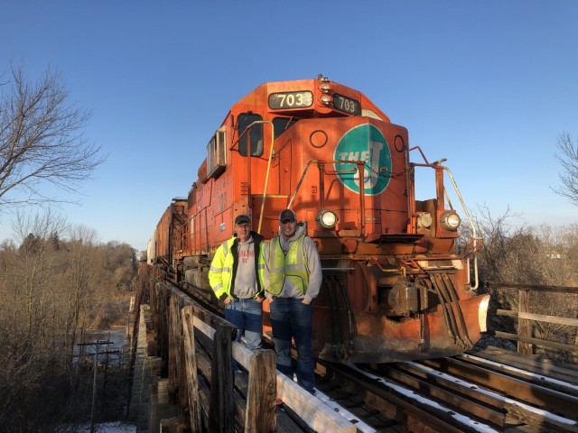 Sgt. 1st Class Jason Elm (left) and U.S. Army 1st Lt. David Elm pose with a locomotive. Both serve in the U.S. Army Reserves 757th Expeditionary Railway Center, headquartered in St. Louis, Mo., as railroaders. Jason currently serves as the rail...