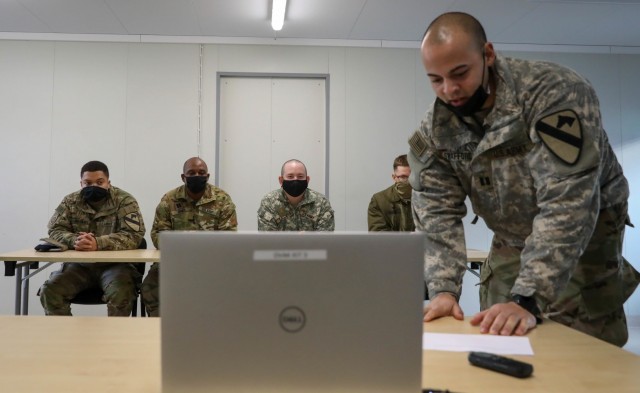 Capt. Spenser Swafford, right, 2nd Battalion, 8th Cavalry Regiment fires support officer, greets Lithuanian military cadets during a video teleconference Jan. 15, 2021, at the Pabrade Training Area, Lithuania. The General Povilas Plechavicius Cadet Lyceum cadets were able to complete a question-and-answer session about the similarities and differences between the NATO allied force militaries. (U.S. Army photo by Sgt. Alexandra Shea)