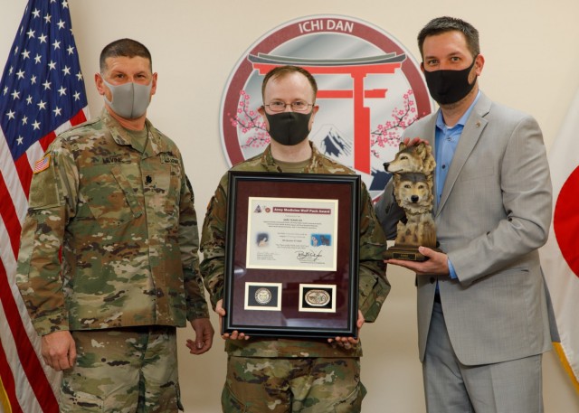 Lt. Col. Matthew Levine, commander of Public Health Activity-Japan, presented representatives of SARS Team Six, Maj. Bradley Kearney, a biochemist and former Public Health Command-Pacific Laboratory Sciences director, and Gary Crispell, a PHC-P microbiologist, the 4th Quarter and Fiscal Year 2020 Wolf Pack Awards for their support as the lead clinical testing team for COVID-19 for U.S. Forces Japan during a virtual ceremony Jan. 20, 2020, at Camp Zama, Japan. The Wolf Pack Award recognizes exceptional teamwork by an integrated group of military and civilian team members focused on excellence in support of Army Medicine. (Photo by Momoko Shindo)